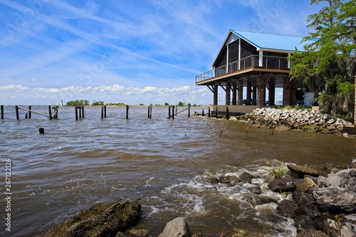 A vacation home on the shore of Lake Pontchartrain in Madisonville, Louisiana with a view of a light hose photo