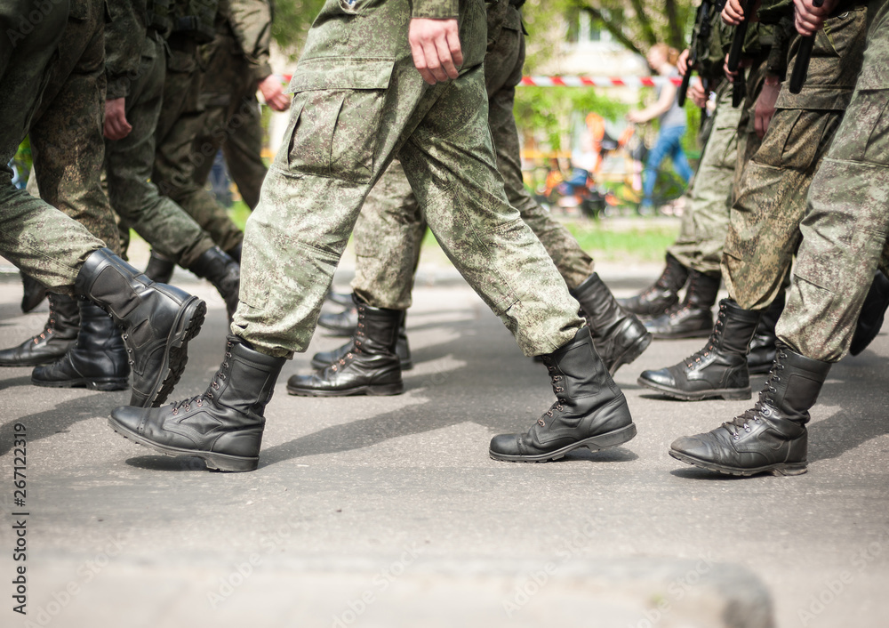 Marching soldiers in military boots Marching soldiers in military boots