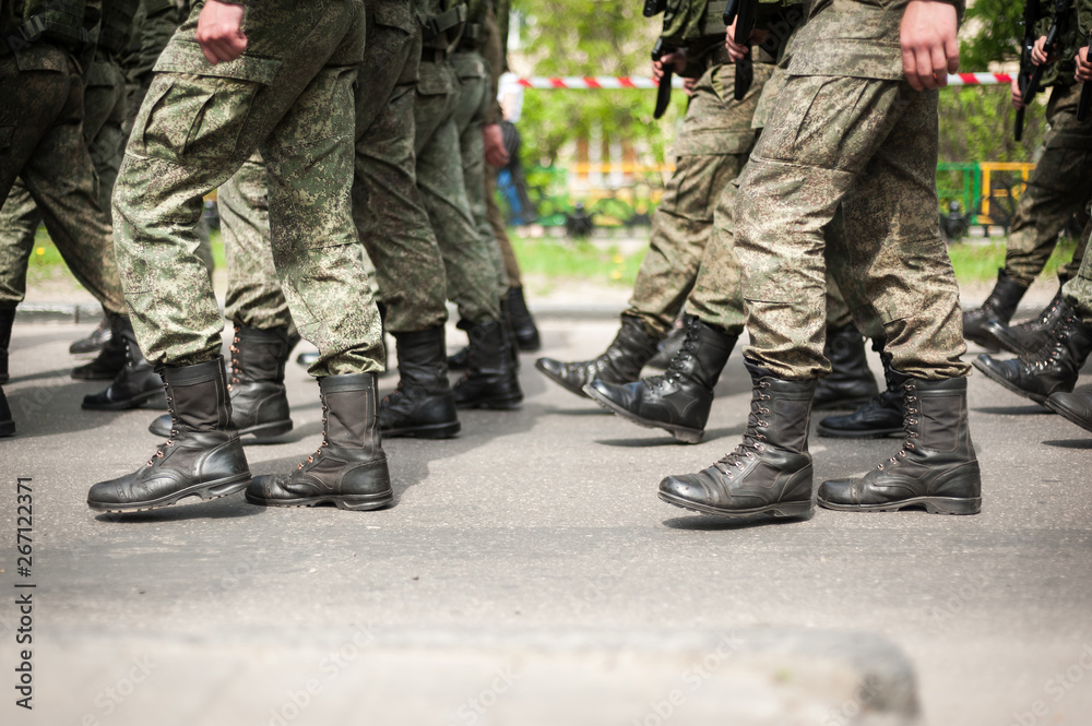 Marching soldiers in military boots Marching soldiers in military boots
