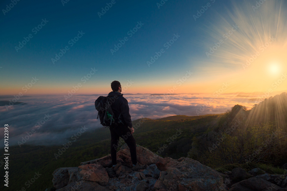 A man in mountain sunset autumn