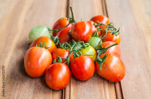 tomatoes on wooden background © thitisan