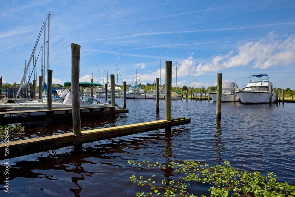Boats moored in a marina in Bayou Libery in Slidell, Louisiana on a sunny spring day