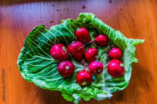 redishes in basket on wooden table photo