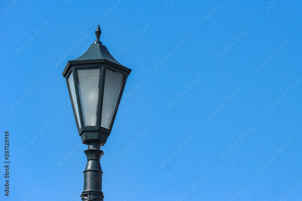 A vintage light lamp with clear blue sky background.