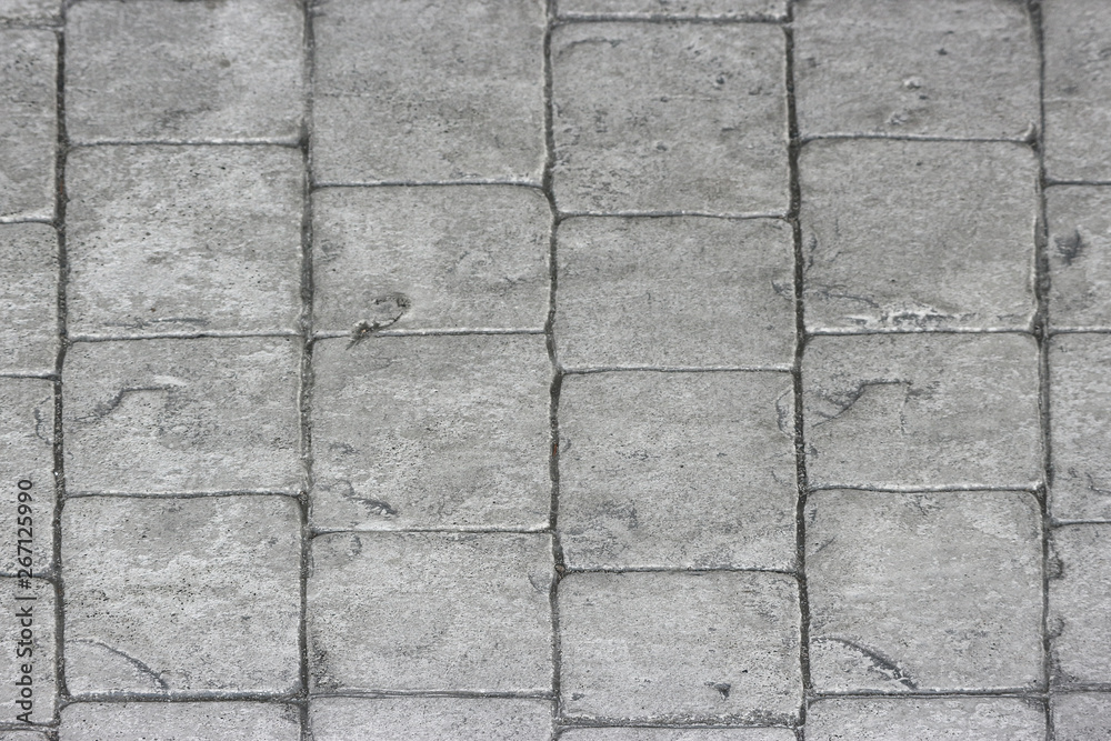Fototapeta premium aged weathered gray stone paving walking way surface background.