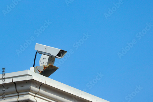 an old Security camera watching the safty for everyone fron high place at public park.