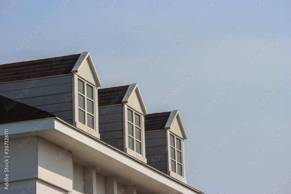 perspective view of modern gable roof design house wall with evening sky background.