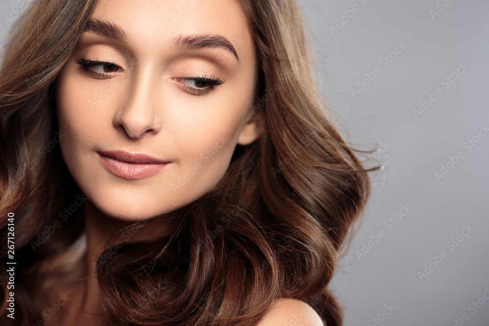 Brunette girl with healthy curly hair and natural make up . Beautiful model woman with wavy hairstyle .Care and beauty Brunette girl with healthy curly hair and natural make up . Beautiful model woman with wavy hairstyle .Care and beauty