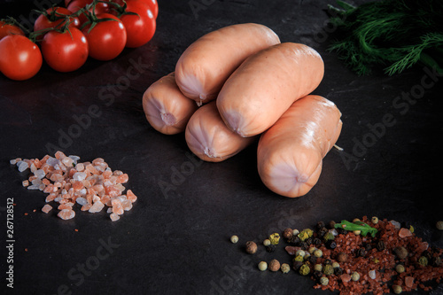 small group of thick short sausages with dill and tomatoes