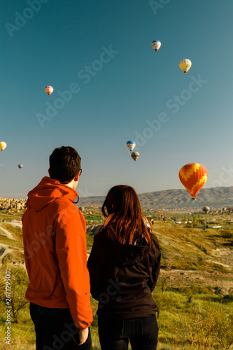 Lovers Couple watching balloons flying in cappadocia, turkey