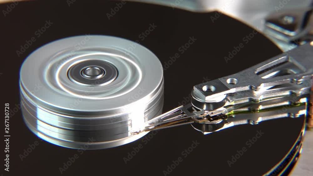 Close-up of an operating computer harddisk reading and writing data Close-up of an operating computer harddisk reading and writing data