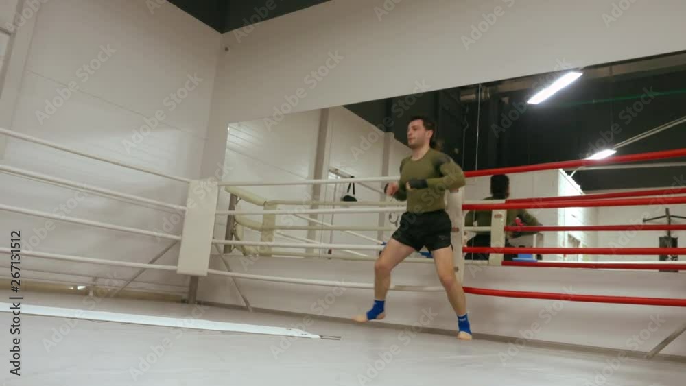 Fighters training somersault at box ring in fight club. Boxer tumbling while personal training with coach in box club. Cardio exercise. Sport motivation. Fighters training somersault at box ring in fight club. Boxer tumbling while personal training with coach in box club. Cardio exercise. Sport motivation.