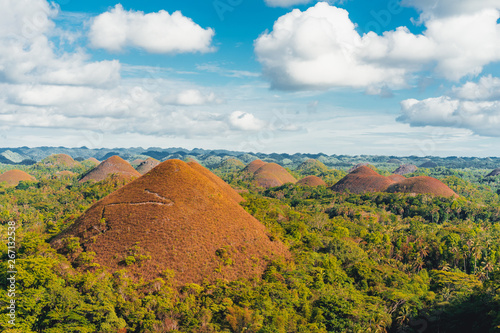 Chocolate Hills in the Bohol island in the Philippines, covered in brown grass. Famous touristic place