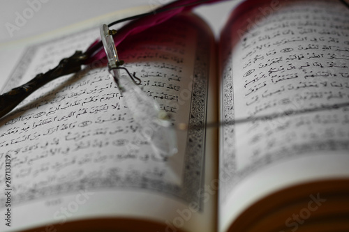 Glasses and a pen on the Koran