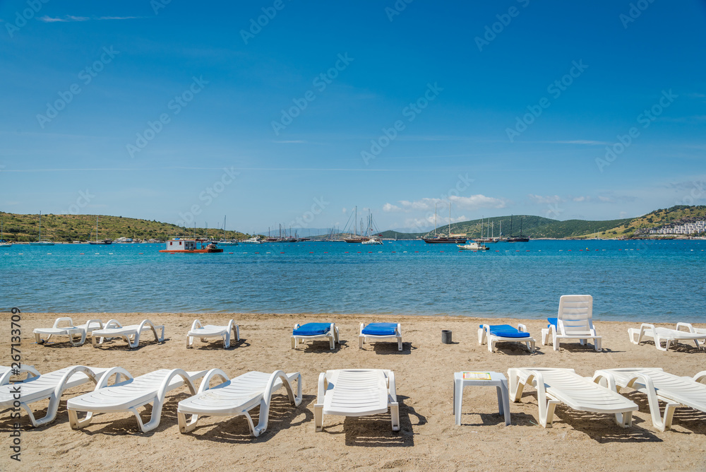 Beautiful exotic beach with deck chairs in Bodrum, Turkey