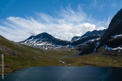 Fototapeta Naklejka Na Ścianę i Meble -  View over lake and mountains with cloudy sky in Norway
