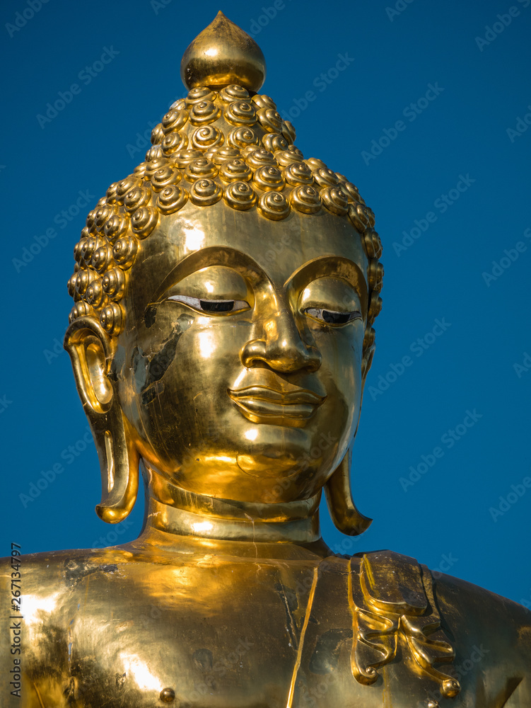 Big golden Buddha in blue sky