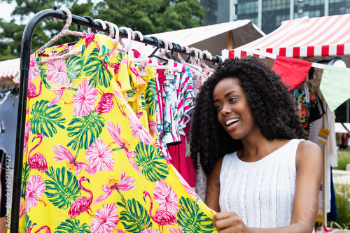 Photography Young african american woman looking for new clothes at market