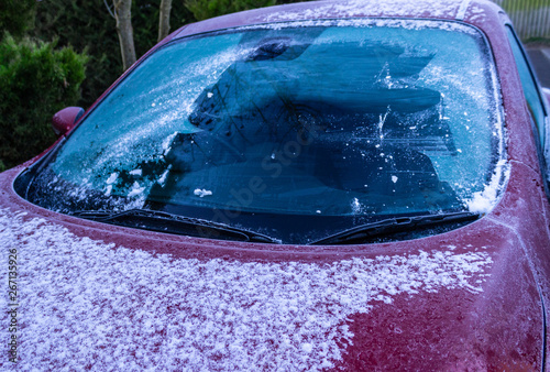 Purple car covered in frost on a very cold winter morning