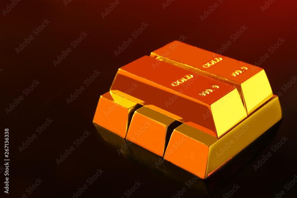 Precious shiny gold bars on mirror surface, space for text Precious shiny gold bars on mirror surface, space for text
