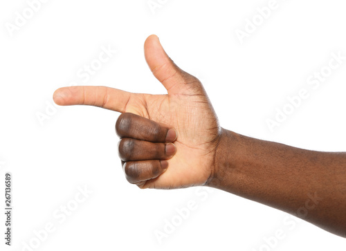 African-American man pointing at something on white background, closeup