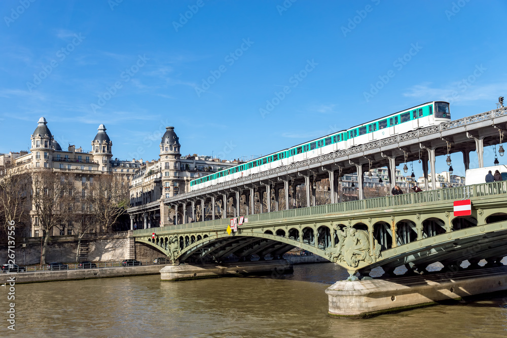 Metro traffic on Pont Bir-Hakeim (Passy viaduc) with view over Passy station buildings - Paris, France