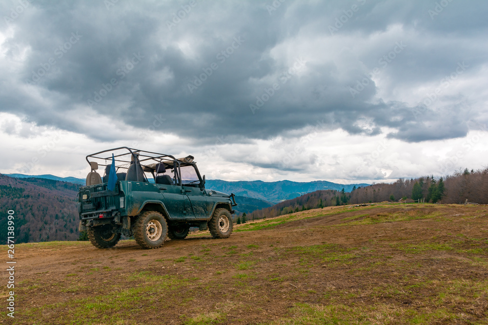 Extreme tourist trip to the top of the mountain on the dirt and stones on a special off-road Jeep to see the beauty of the mountains and forests on the horizon on top of the world Extreme tourist trip to the top of the mountain on the dirt and stones on a special off-road Jeep to see the beauty of the mountains and forests on the horizon on top of the world