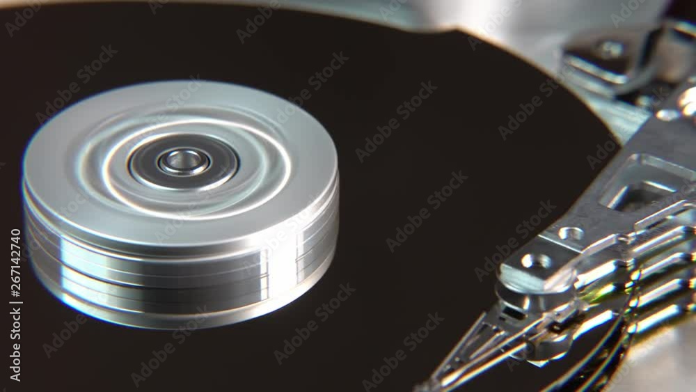 Close-up of an operating computer harddisk reading and writing data Close-up of an operating computer harddisk reading and writing data