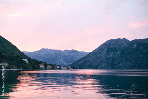 Beautiful view of the sunset or sunrise and the natural landscape with the sea and hills or mountains in Montenegro in the summer. Far coastal city. © franz12