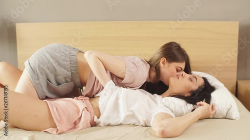 Two sexual girls sharing intimacy with each other.