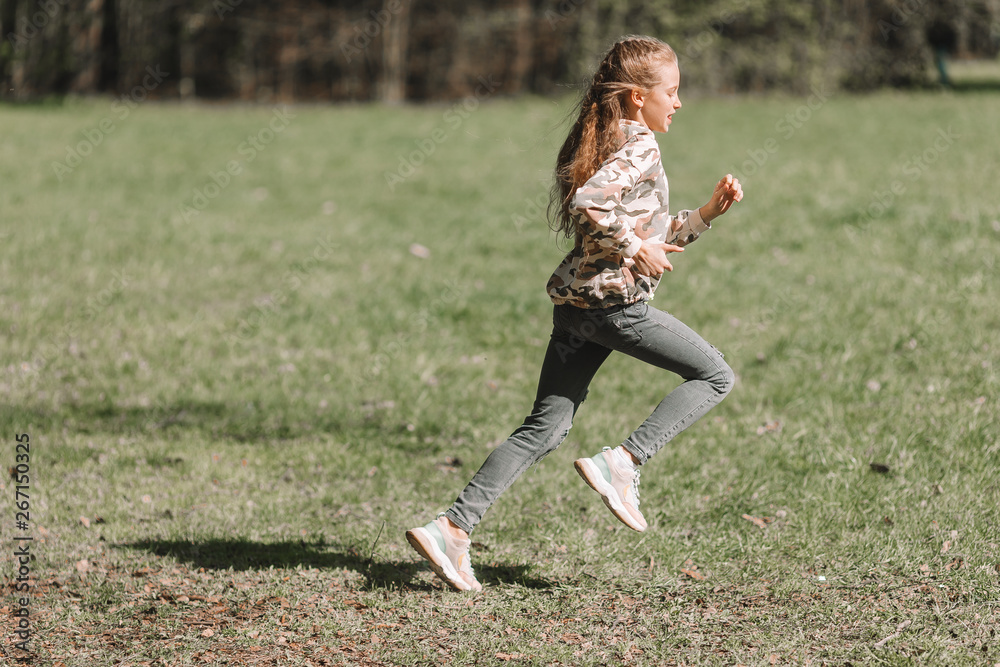 Little girl in outdoor park on her weekend Little girl in outdoor park on her weekend