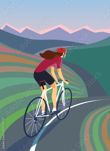 Cyclist woman riding near the hills and mountains