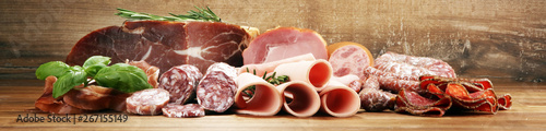 Fotografie cold meat assortment with delicious salami and  fresh herbs