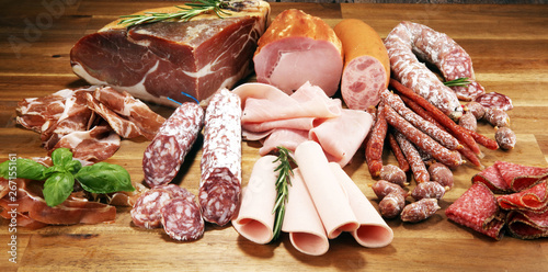 cold meat assortment with delicious salami and fresh herbs . Variety of meat products including coppa and sausages