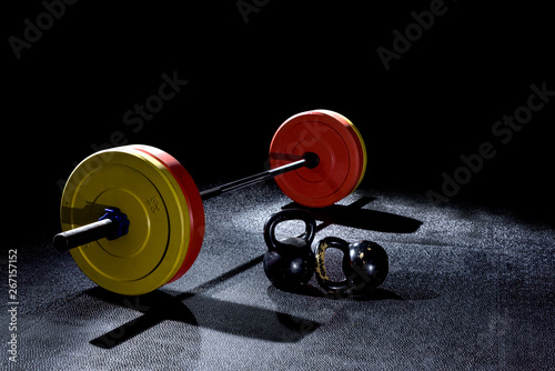 Bumper plates in gym with dramatic lighting photo