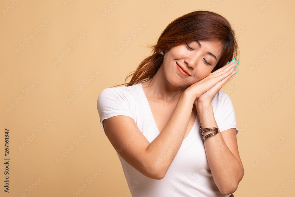 Beautiful young Asian woman with sleeping gesture. Beautiful young Asian woman with sleeping gesture.