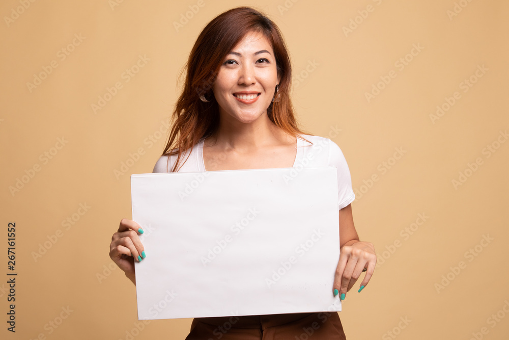 Young Asian woman with white blank sign. Young Asian woman with white blank sign.