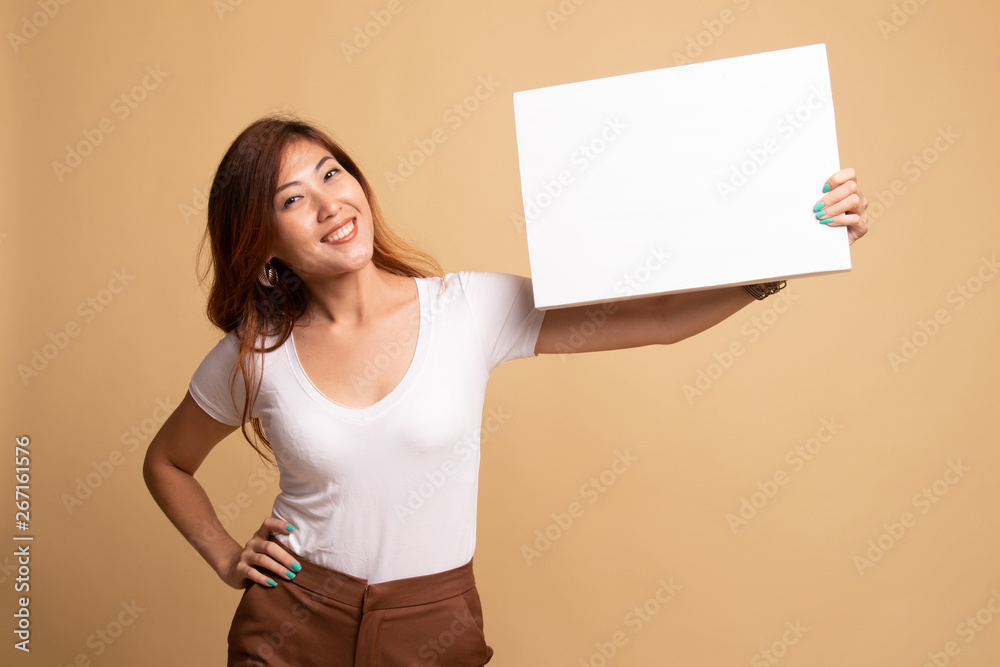 Young Asian woman with white blank sign. Young Asian woman with white blank sign.