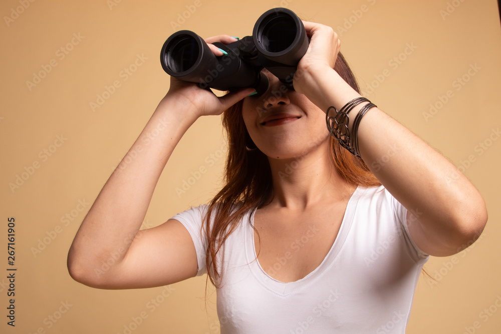 Young Asian woman with binoculars. Young Asian woman with binoculars.