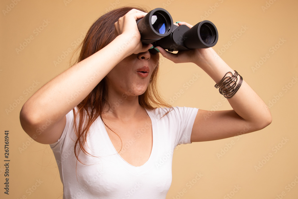 Young Asian woman with binoculars. Young Asian woman with binoculars.