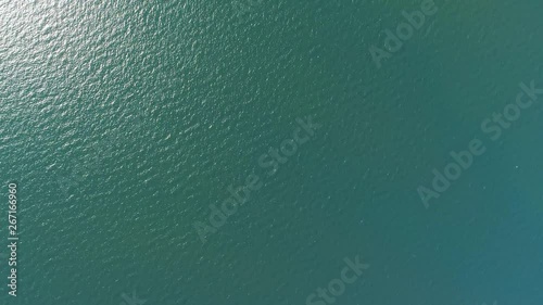 Aerial top down view from high altitude of green sea water texture