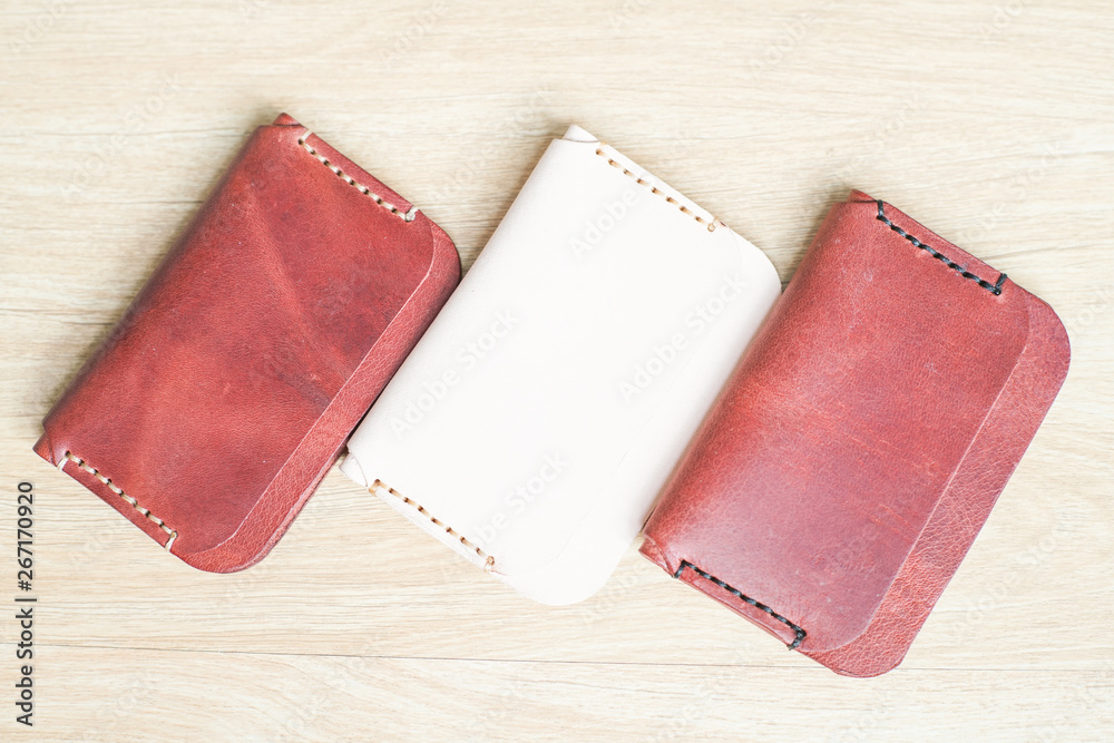 Red brown leather card holder on wood Red brown leather card holder on wood