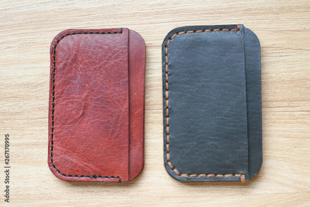 Red brown leather card holder on wood Red brown leather card holder on wood