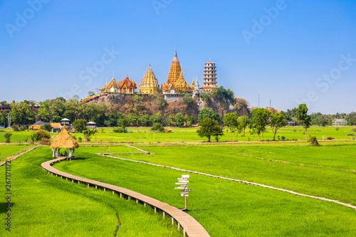 Landscape of Wat Tham Sua Temple (Tiger Cave Temple) with Jasmine rice fields at Kanchanaburi Province, Thailand. Is an important landmark that everyone must visit photo
