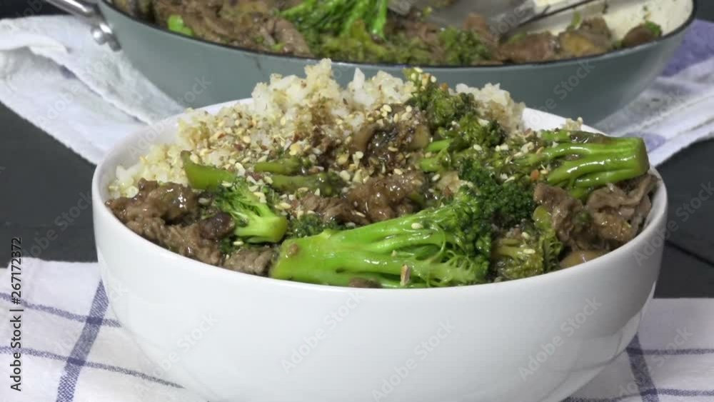 Eating beef and broccoli with chop sticks Eating beef and broccoli with chop sticks