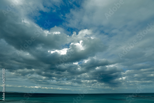 A huge dark blanket covers the wide ocean