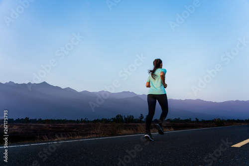 Woman enjoy running outside with beautiful summer evening in the countryside.