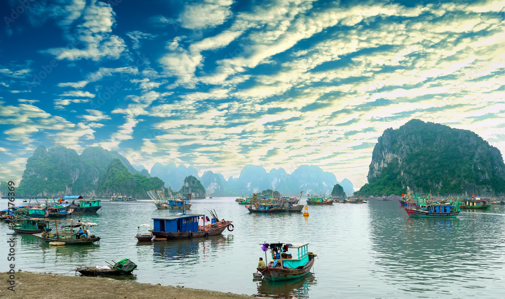 Cat Ba Harbor in Halong Bay, Vietnam with many fishing boats anchored. This is considered a natural World Heritage Site