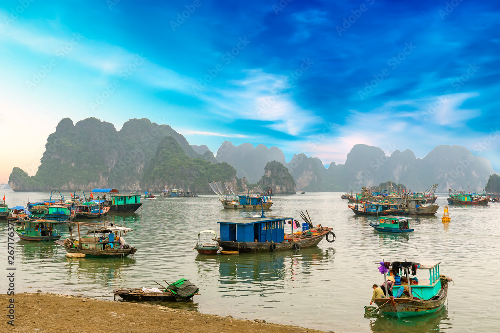 Cat Ba Harbor in Halong Bay, Vietnam with many fishing boats anchored. This is considered a natural World Heritage Site