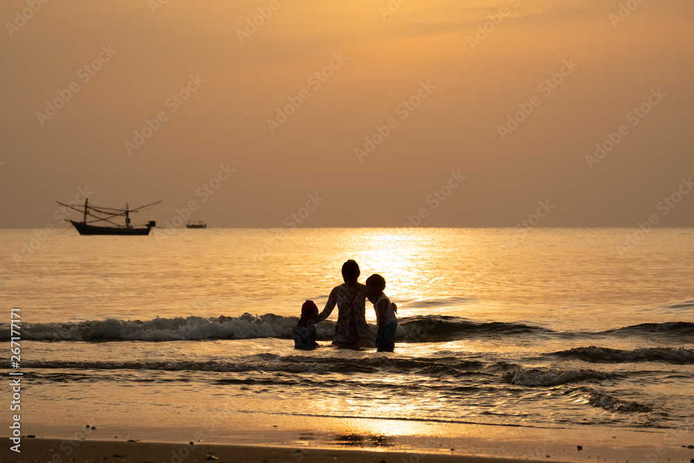 silhouette view of family take a vacation in the summer time with sea scape